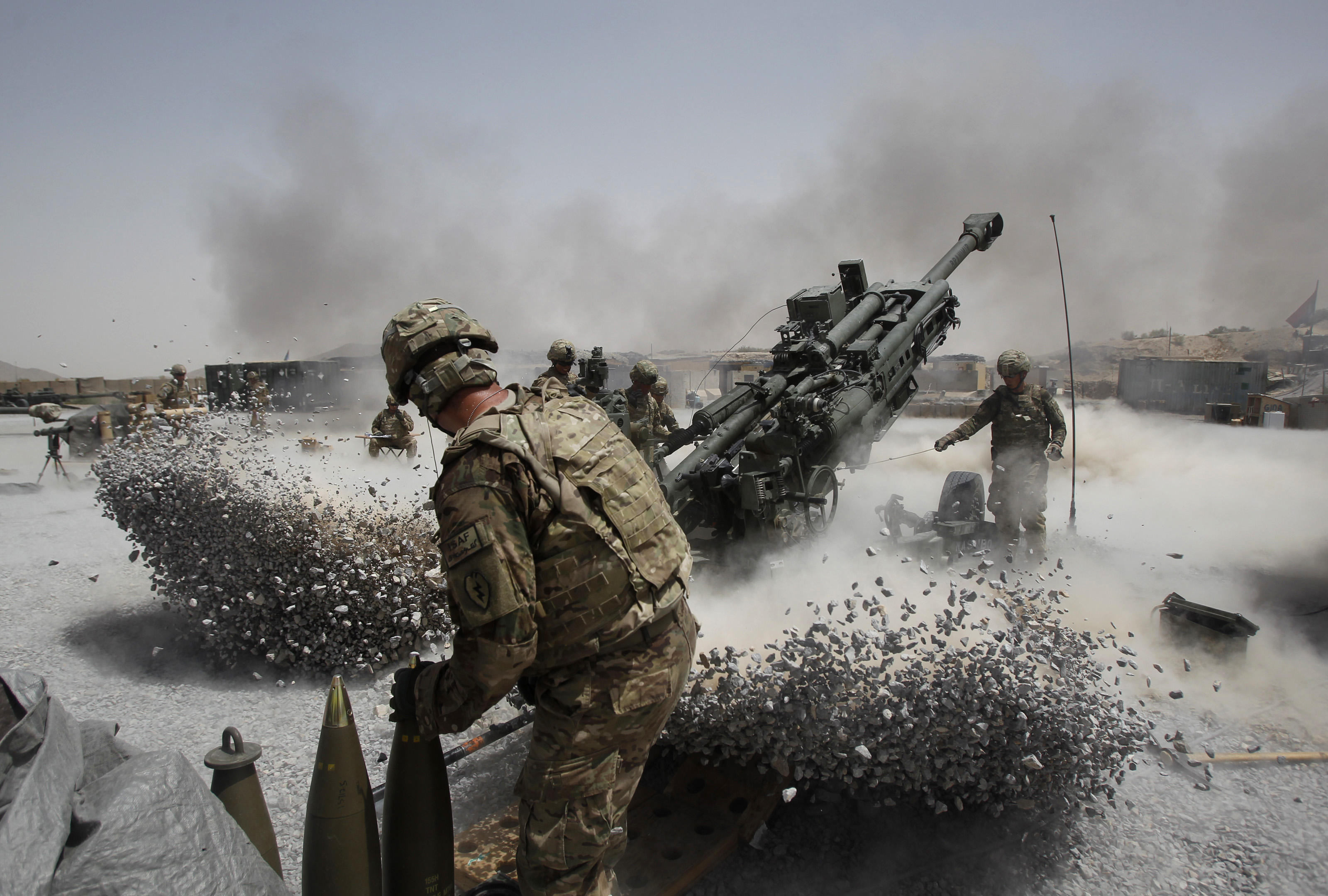 U.S. Army soldiers from the 2nd Platoon, B battery 2-8 field artillery, fire a howitzer artillery piece at Seprwan Ghar forward fire base in Panjwai district